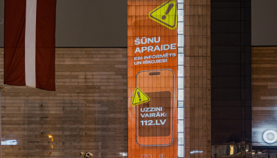 Brīdinājuma paziņojums orandžā krāsā uz pilsētvides ekrāna